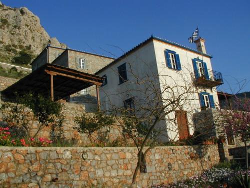 a building on top of a stone wall at Hydra Erato in Hydra