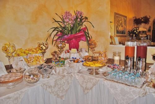 a table with a white table cloth with food on it at Hotel Italia in Lerici