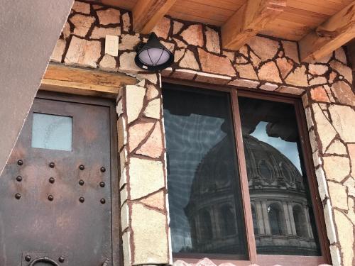a front door of a stone building with a window at Hotel Spa Casa del Sol in Guanajuato