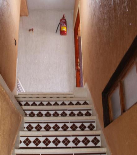 an overhead view of a stairway with a fire extinguisher at Dar Imperial in Imlil