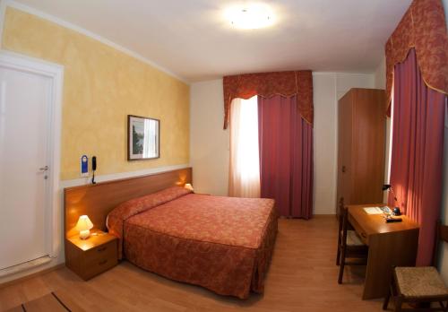 Postel nebo postele na pokoji v ubytování Hotel Pinamonte