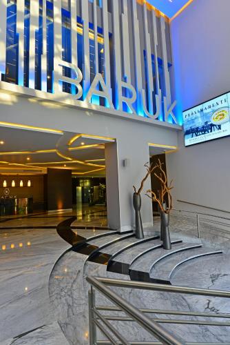 a lobby of a building with two vases in front of it at Baruk Guadalajara Hotel de Autor in Guadalajara