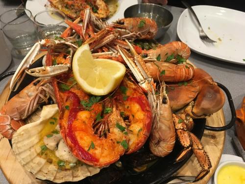 a plate of shrimp and other seafood on a table at Highland Croft B&B in Onich