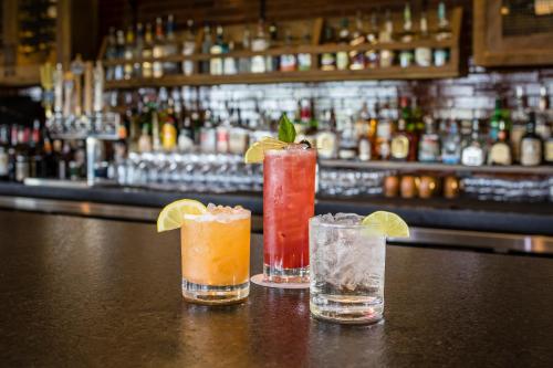 a group of three cocktails sitting on a bar at Sage Lodge in Pray