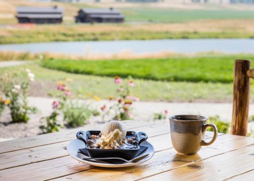 a plate of food and a cup of coffee on a table at Sage Lodge in Pray