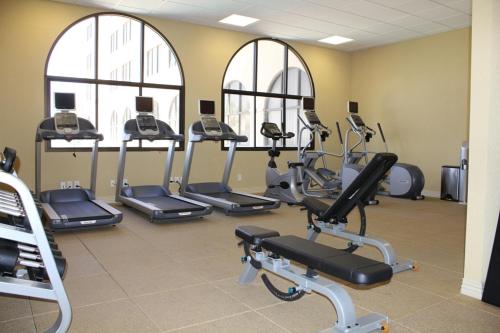 a gym with several tread machines in a room at Hotel Encanto de Las Cruces in Las Cruces