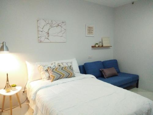 una camera con letto e sedia blu di Cloud 907 Cityscapes Condominium a Bacolod