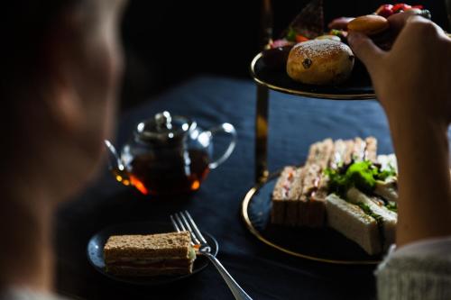 a person sitting at a table with a plate of food at The Chesterton Hotel in Bicester