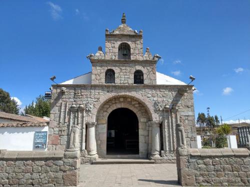 a church with a tower on top of a building at Hotel Rincon Aleman in Riobamba