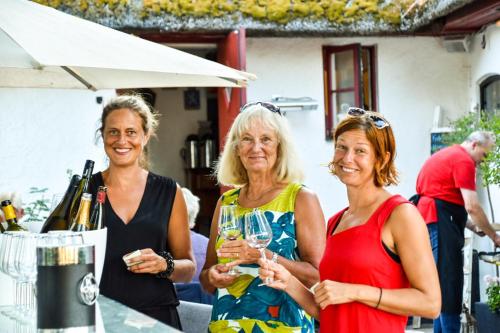 a group of three women holding wine glasses at Sydkustens at Pillehill in Skivarp