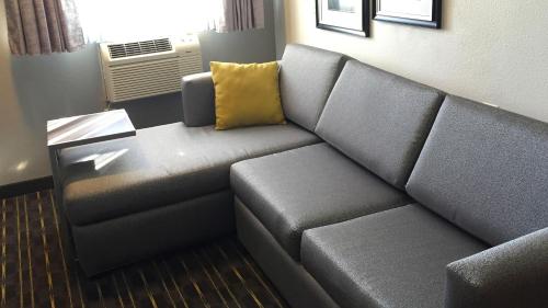 a living room with a couch and a table at Comfort Inn & Suites Tigard near Washington Square in Tigard