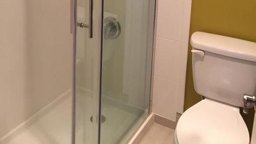 a bathroom with a toilet and a glass shower at Comfort Inn & Suites Tigard near Washington Square in Tigard