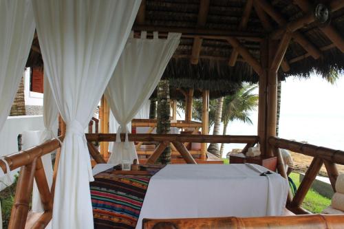 a bed in a room with white drapes at Royal Decameron Mompiche - All Inclusive in Mompiche