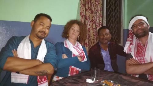 a group of people sitting at a table at Bhaskar Homestay in Dibrugarh