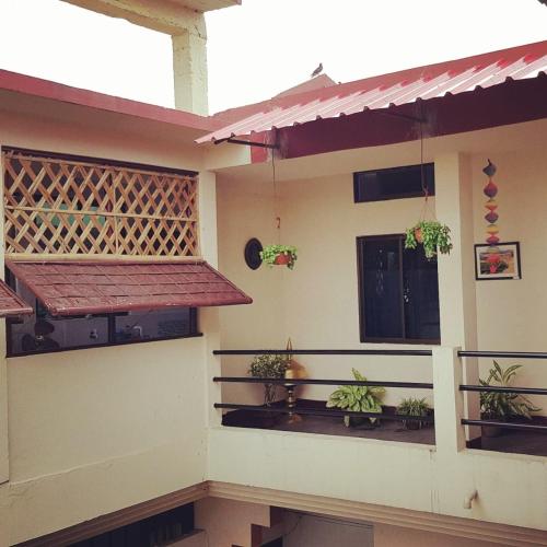 a house with plants on the side of it at Bhaskar Homestay in Dibrugarh