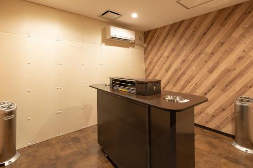 a room with a counter with a microwave on it at Hotel JAL City Nagano in Nagano