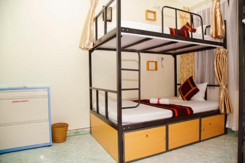 a bunk bed room with two bunk beds in a room at Hanoi City Backpackers Hostel in Hanoi