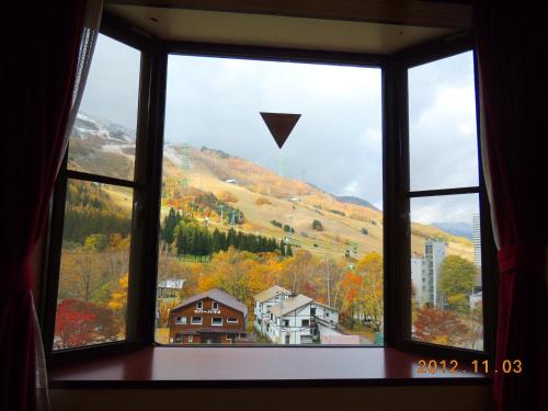 a window with a view of a mountain view at Naeba Lodge Oka in Yuzawa
