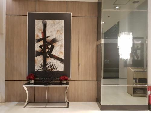 a framed picture of a cross on a wall at Your HOME @ Princeton Residences, New Manila in Manila