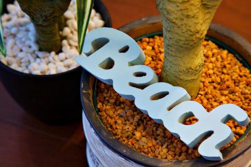 a sign that says seed next to a plant at La Fonte UK2 in Ginowan