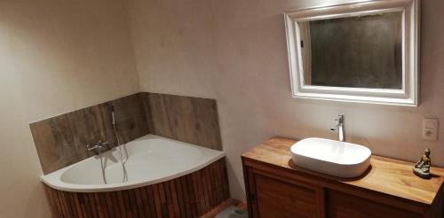 a bathroom with a bath tub and a sink at maison familiale près de bruxelles et paridaisia in Enghien