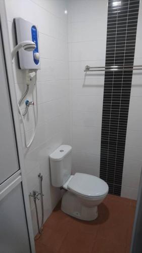 a bathroom with a white toilet and a shower at Hotel Mill Road in Malacca