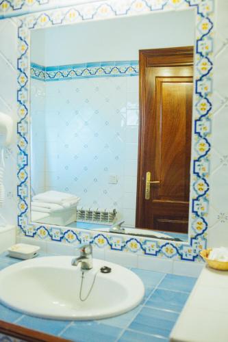 a bathroom with a sink and a mirror at Finca Agroturismo Son Menut in Felanitx