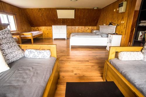 a bedroom with two beds in a room at Chalupa Přeslička in Rejvíz