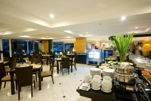 a restaurant with tables and chairs and a buffet at Kantary House Hotel, Bangkok in Bangkok