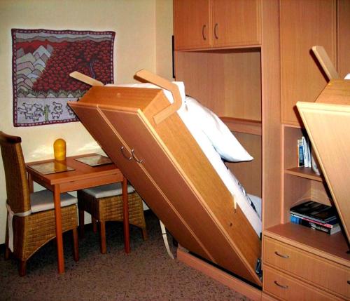 a bedroom with a bunk bed with a desk and a desk at Finke in Travemünde