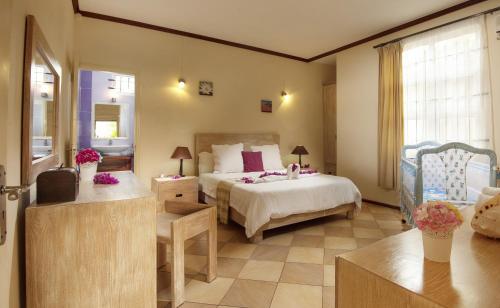 a bedroom with a bed and a living room at Talamba Blue in Blue Bay