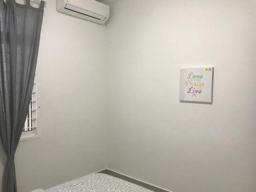 a white wall with a sign that reads love panic fire at SINGGAH Putrajaya - 3 Bedrooms with Pool and KL View in Putrajaya