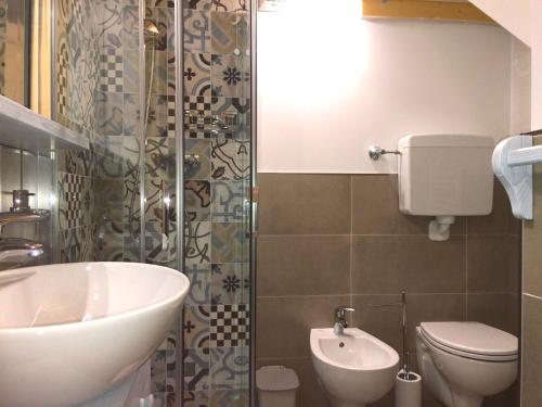 a bathroom with a sink and a toilet and a shower at B&B Contrade Alte in SantʼAnna dʼAlfaedo