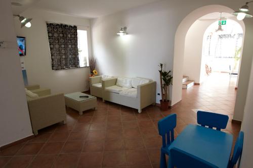 a living room with a couch and a table and chairs at Yachting Club Mare in Patti