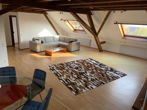 a living room with a couch and a glass table at Gasthof National in Langendorf