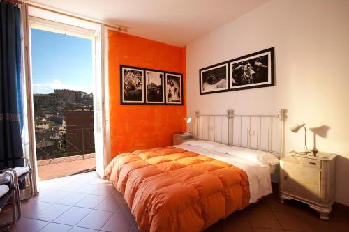 a bedroom with a bed and a window at B&B Le Lupe in Siena