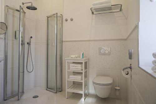 a white bathroom with a shower and a toilet at Vila Mila in Bled