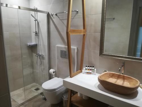 a bathroom with a sink and a toilet and a shower at Amaryllis in Nafpaktos