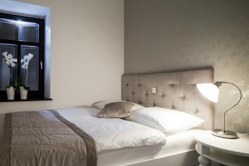 a bedroom with a bed with a lamp and a window at Vila Mila in Bled