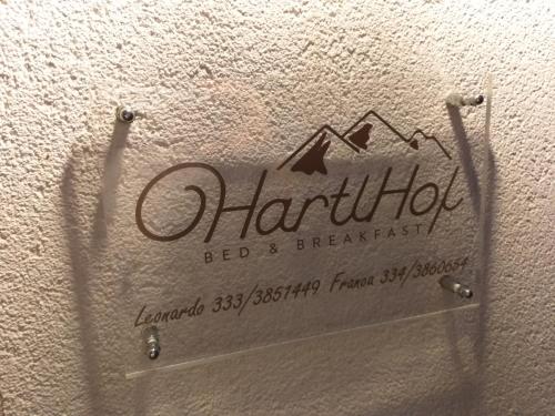 a sign for a bed and breakfast on a wall at HartlHof in Proves