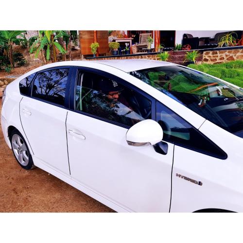 a white car parked in a parking lot at Leisure Dream Inn in Ella