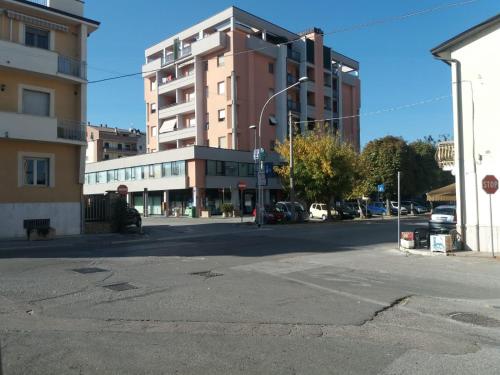 an empty city street with a tall building at Casa Vacanze "Ai piedi di Assisi" in Bastia Umbra