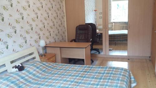 a bedroom with a bed and a desk and a chair at Harmony Life Two-room apartment in Riga in Rīga
