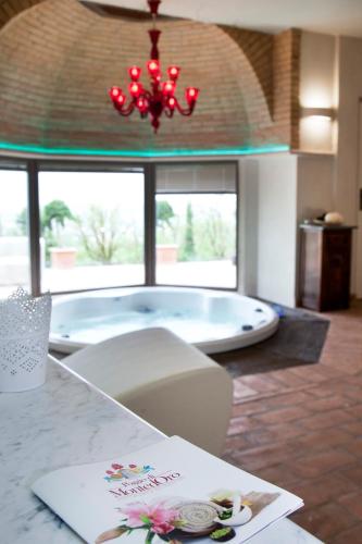 a room with a tub with a book on a table at AgriResort Spa Glamping Poggio Di Montedoro in Montefiascone