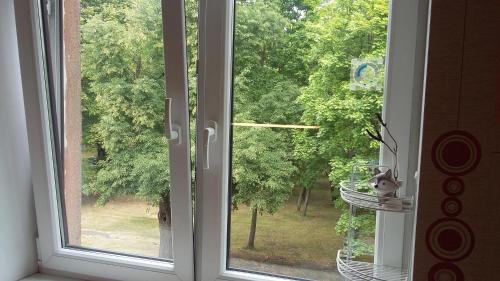 an open window with a view of a tree at Harmony Life Two-room apartment in Riga in Rīga