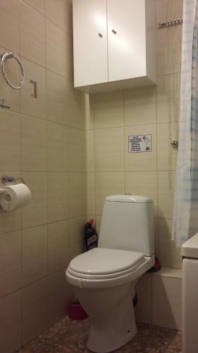 a bathroom with a toilet and a white cabinet at Harmony Life Two-room apartment in Riga in Rīga