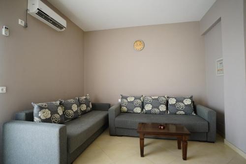 a living room with two couches and a table at Apartments Vila Emiliano in Borsh