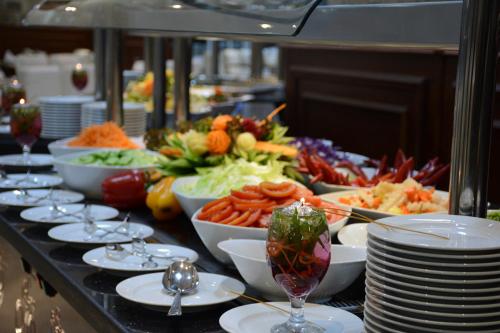 a buffet line with plates and bowls of food at Tolip Inn Maadi in Cairo