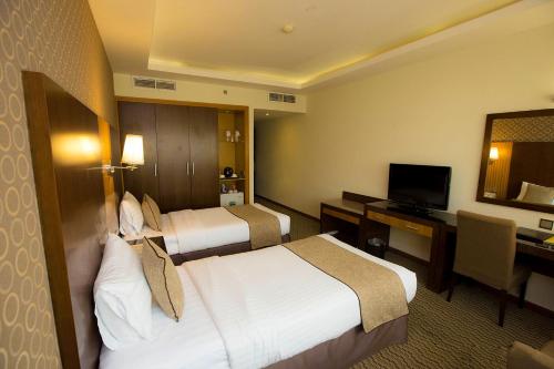 Säng eller sängar i ett rum på Fortune Plaza Hotel, Dubai Airport