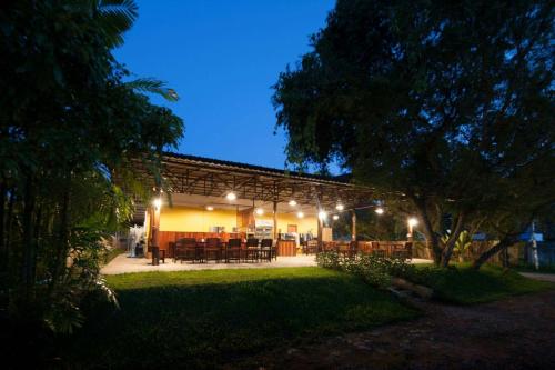 a patio with tables and chairs at night at Chiang Dao Reset in Chiang Dao